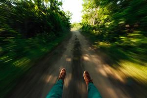 looks like a guy riding a luge on a dirt road